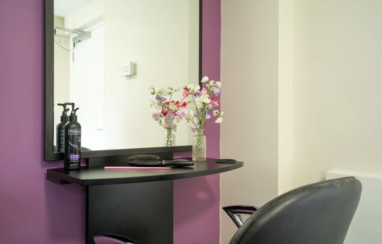 Pratt House hair salon with purple and grey decor