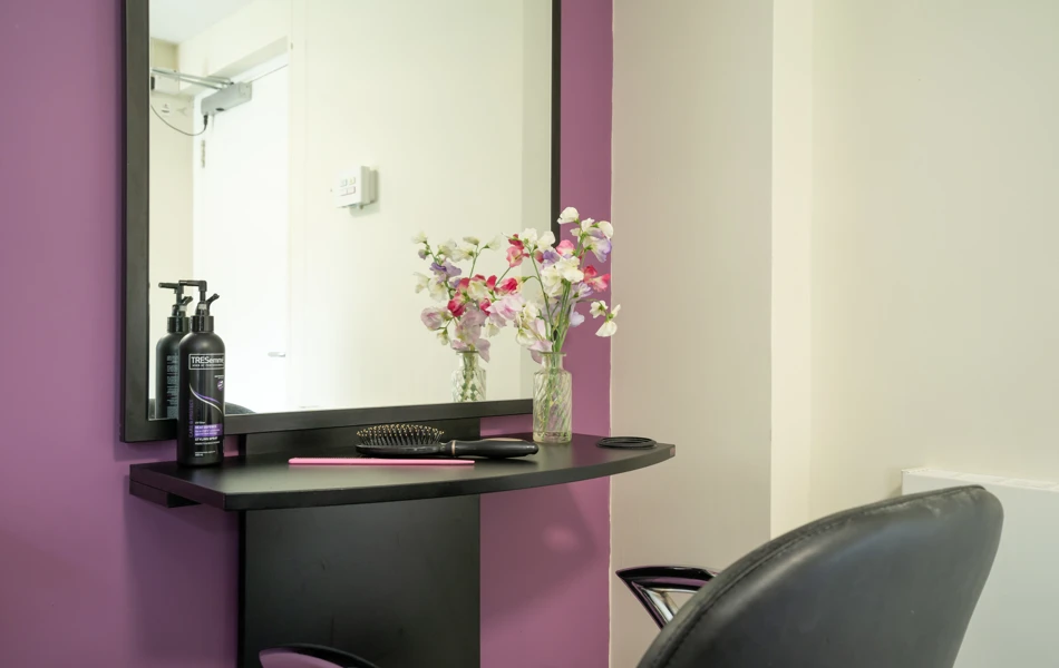 Pratt House hair salon with purple and grey decor