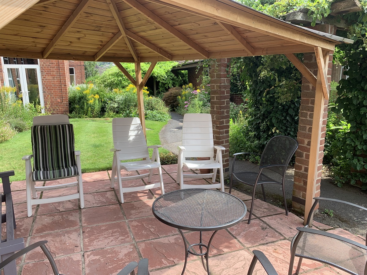 Abbeyfield Firs Complex garden showing wood and brick built gazebo with outdoor seating area
