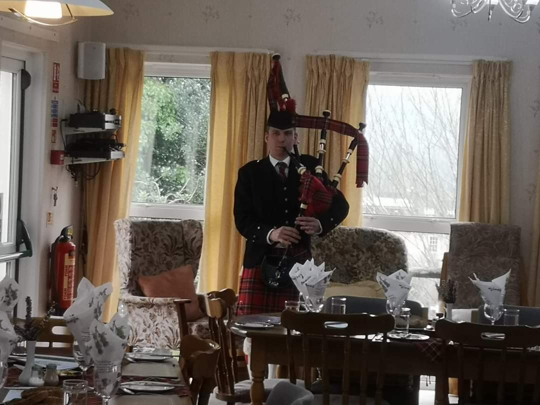 burns-night-piper at Abbeyfield House, Brecon LD3 7RT