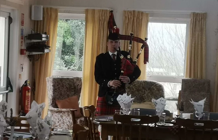 burns-night-piper at Abbeyfield House, Brecon LD3 7RT