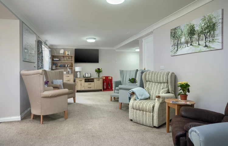 Pratt House lounge in brightly lit room with seating and TV