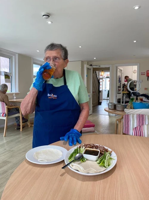 A resident cooking and drinking