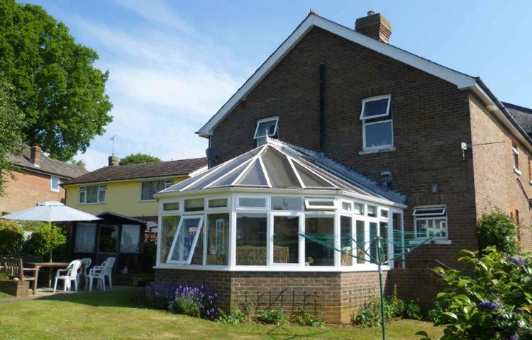 Sunny garden with table and chairs where residents can enjoy a breath of fresh air