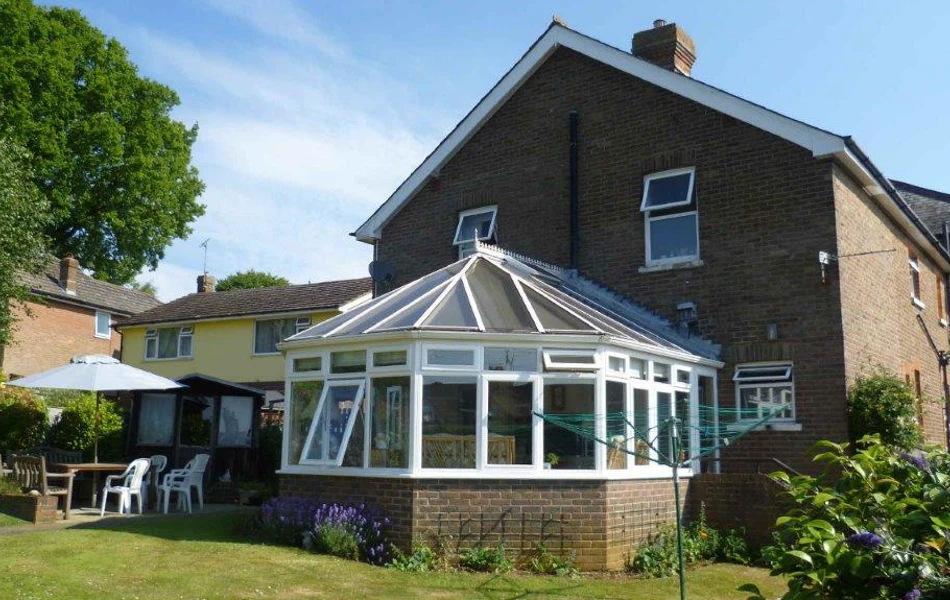 Sunny garden with table and chairs where residents can enjoy a breath of fresh air
