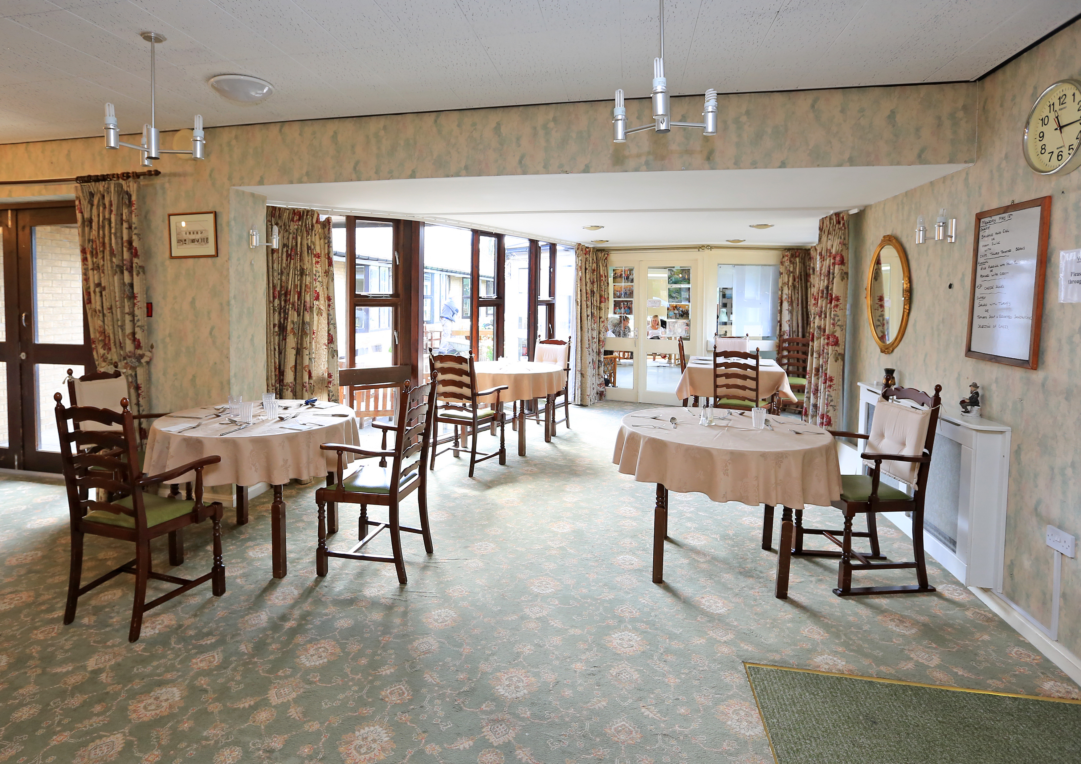 Large bright dining area with tables and chairs