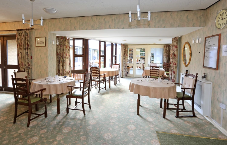 Large bright dining area with tables and chairs