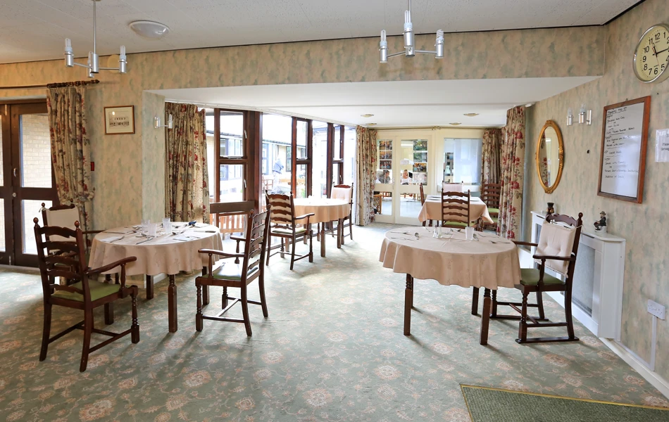 Large bright dining area with tables and chairs