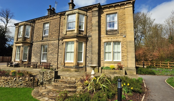 Full view of the house with stone steps into the garden