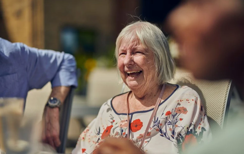 Older Woman Enjoying The Sunshine With Other Residents on Roundhay, GU1 2JH