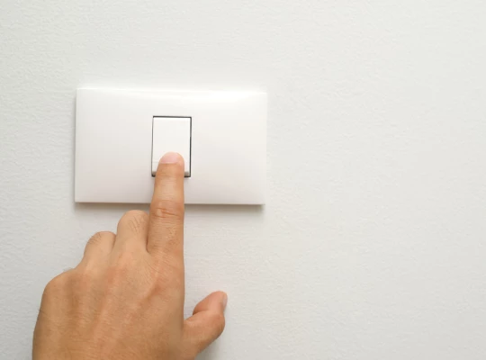 Person Turning Off Light Switch