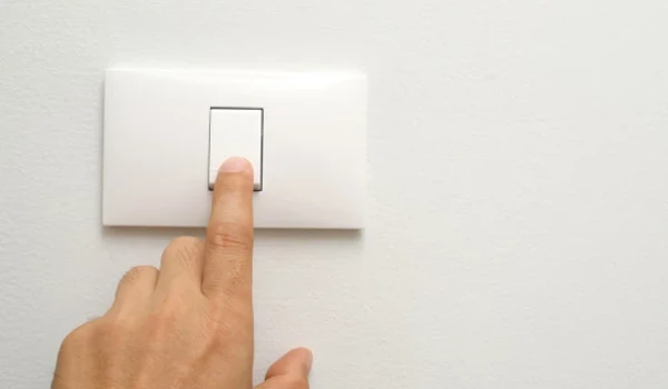 Person Turning Off Light Switch