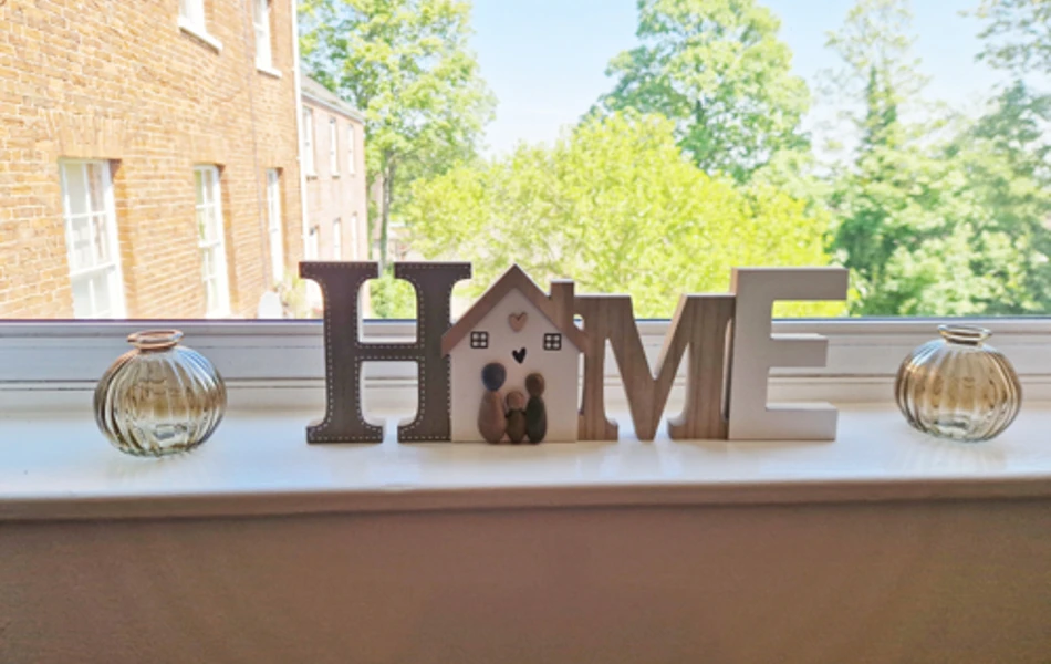 Home Sign On Windowsill At Ivy House