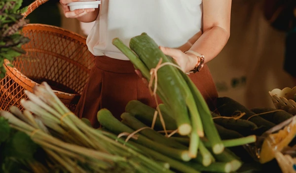 Woman Holding Vegetables And Drink
