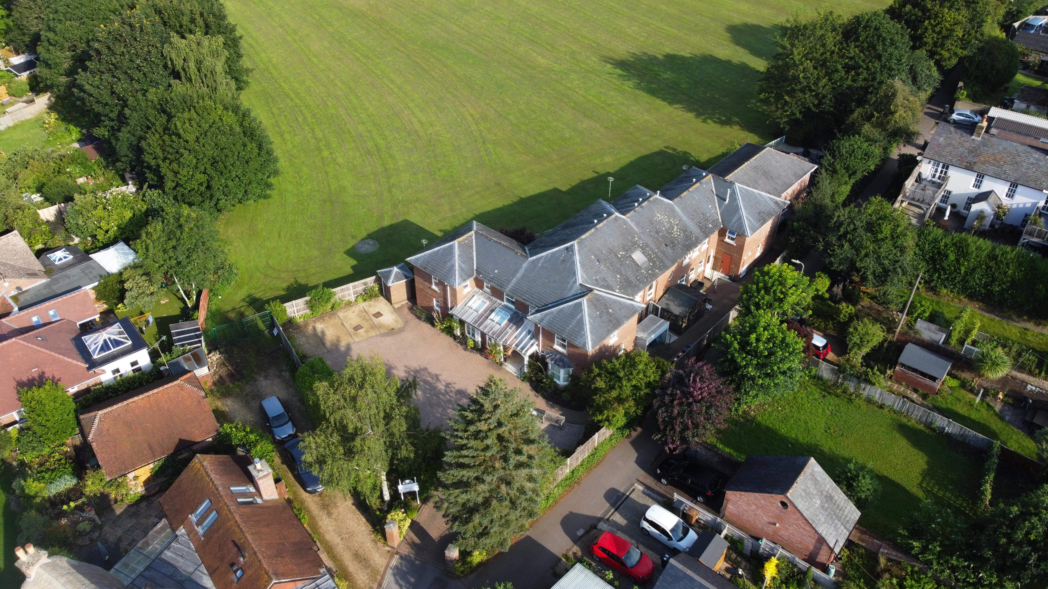 Fields and green spaces surround the house