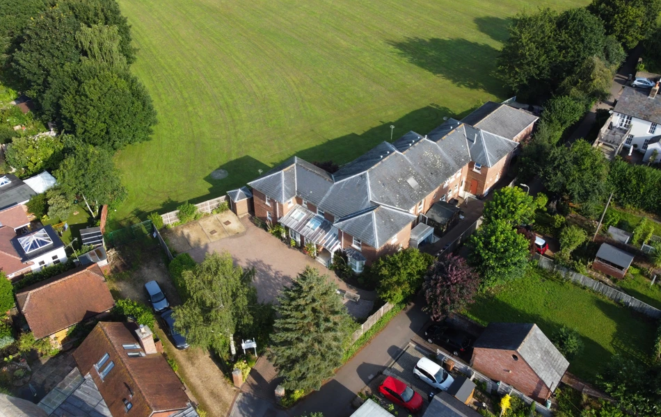 Fields and green spaces surround the house