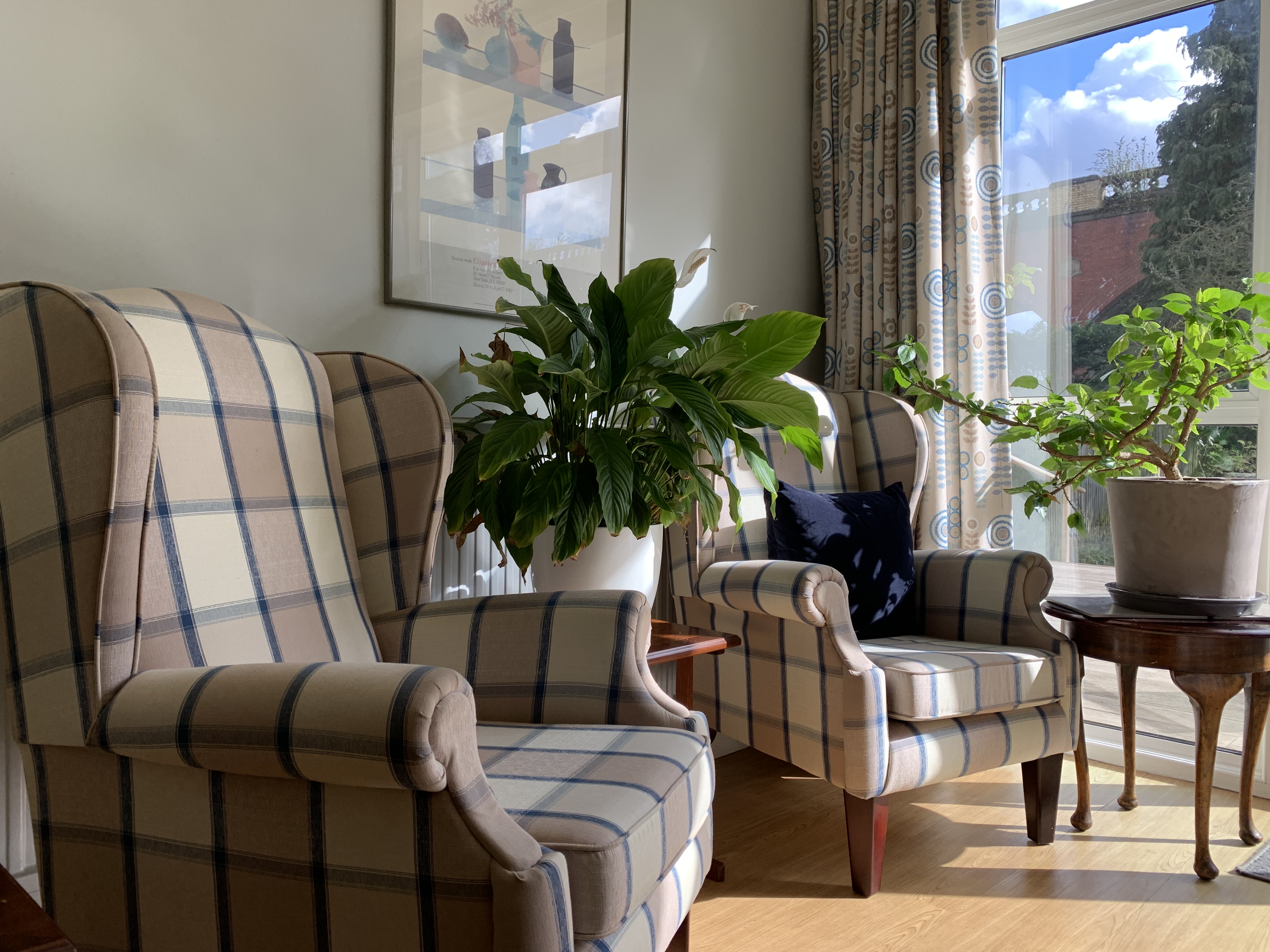 Bright and sunny seating area with armchairs for residents to catch up or relax