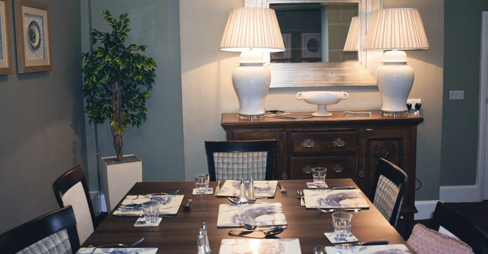 Mahogany dining table set for dinner