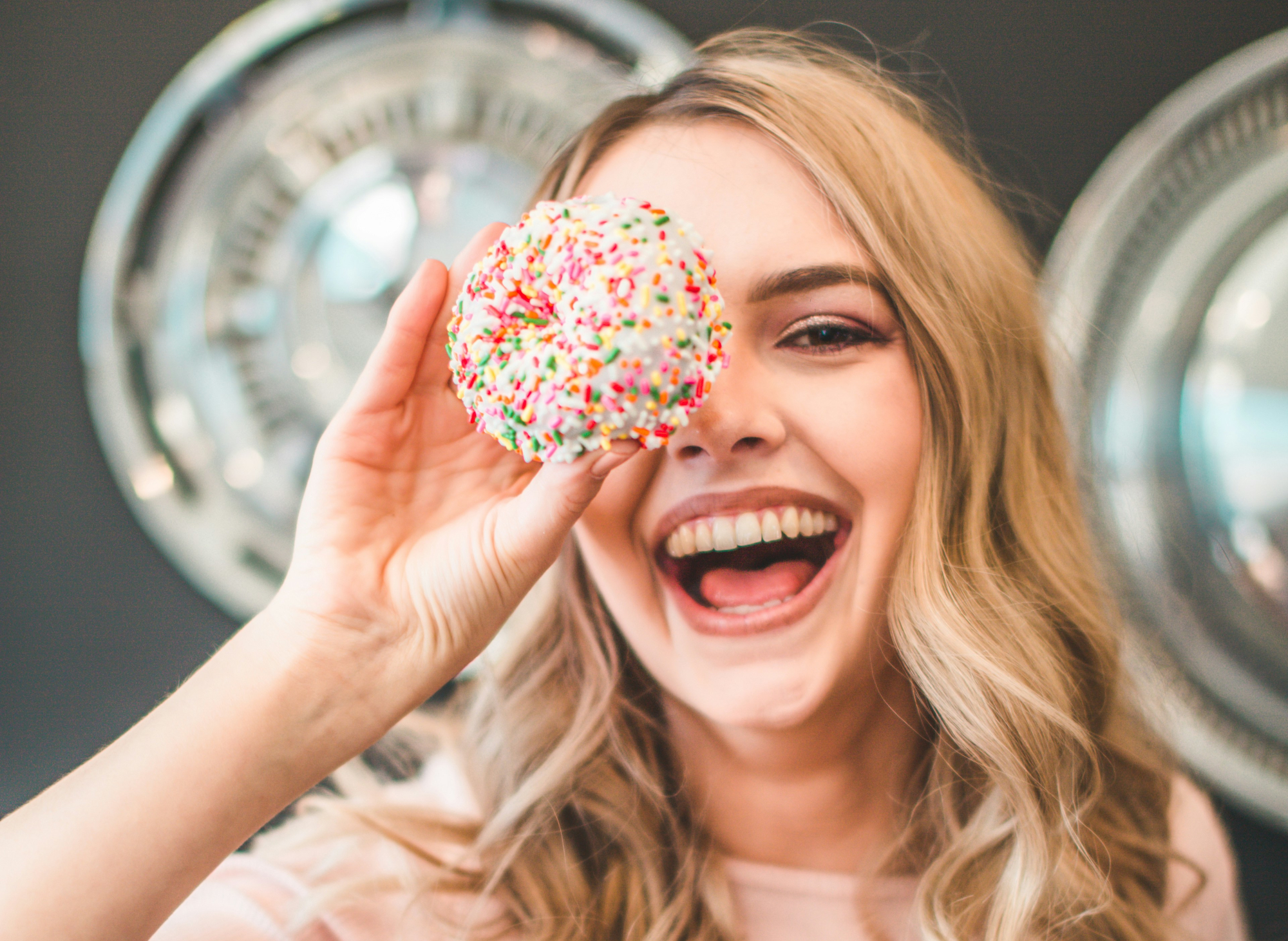 Woman Holding Up Doughnut Over Eye