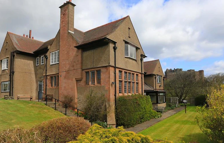 An outside view of Armstrong House and surrounding gardens