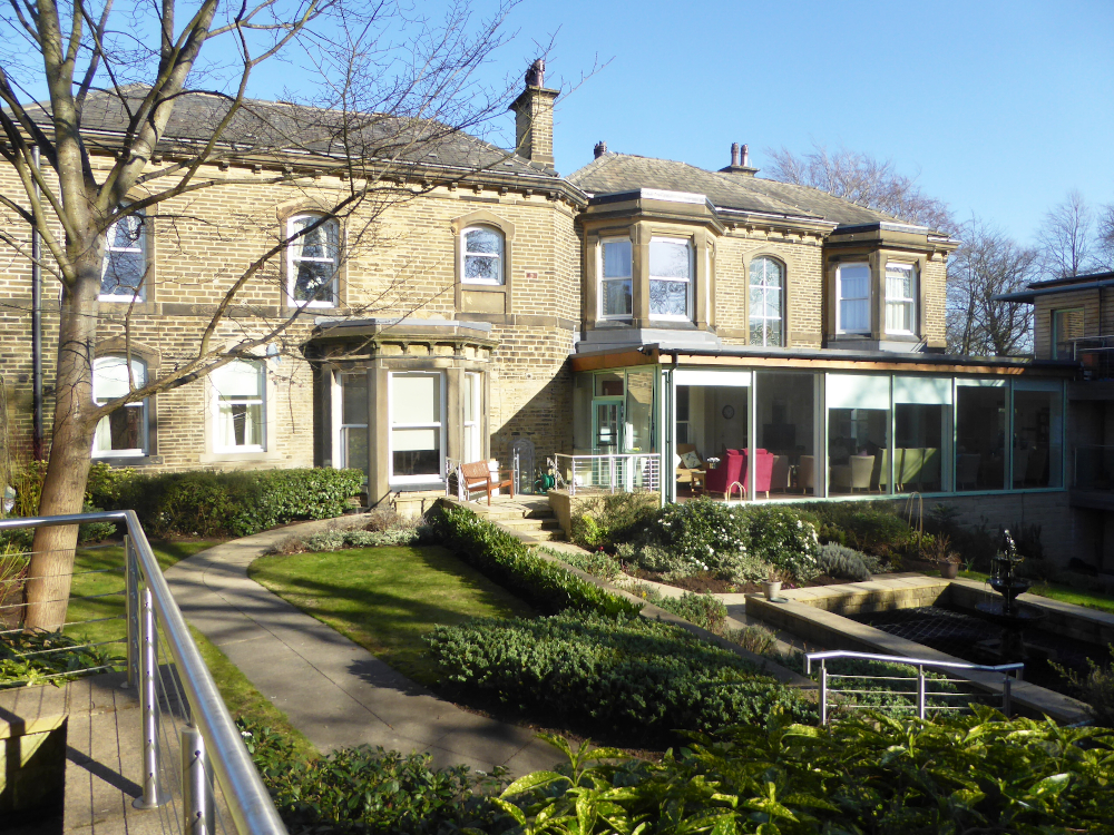 View from outside Abbeyfield Ing Royd with its conservatory, garden and pond independent living in Halifax