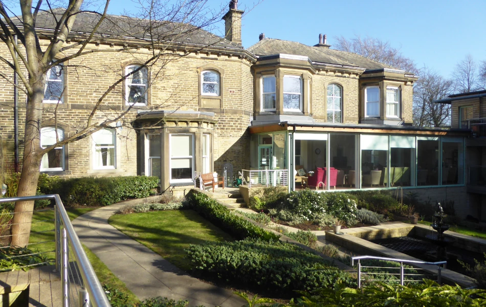 View from outside Abbeyfield Ing Royd with its conservatory, garden and pond independent living in Halifax