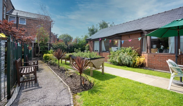 Downing House has seating area for residents to enjoy the garden.