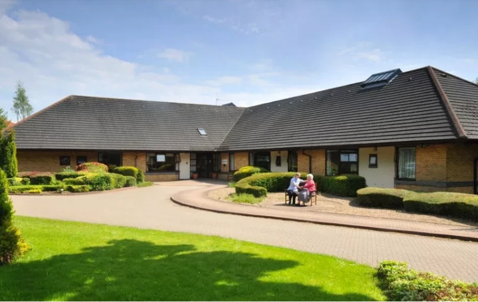 Caste Farm on a sunny day a resident staff sat outside