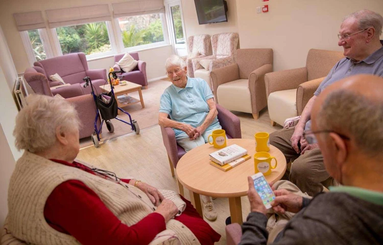 Residents in a lounge at Abbeyfield House, Hove BN3 4GB