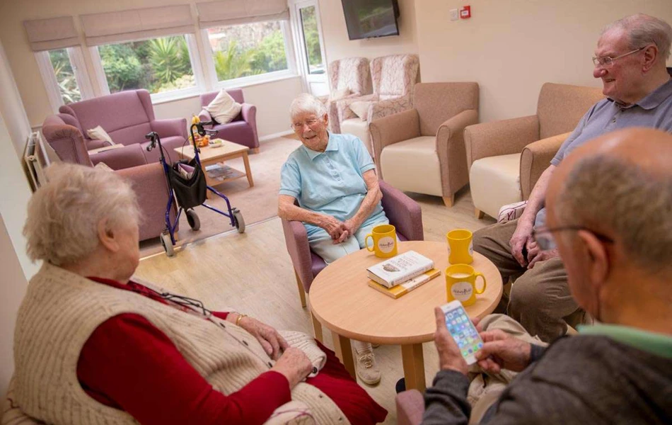 Residents in a lounge at Abbeyfield House, Hove BN3 4GB