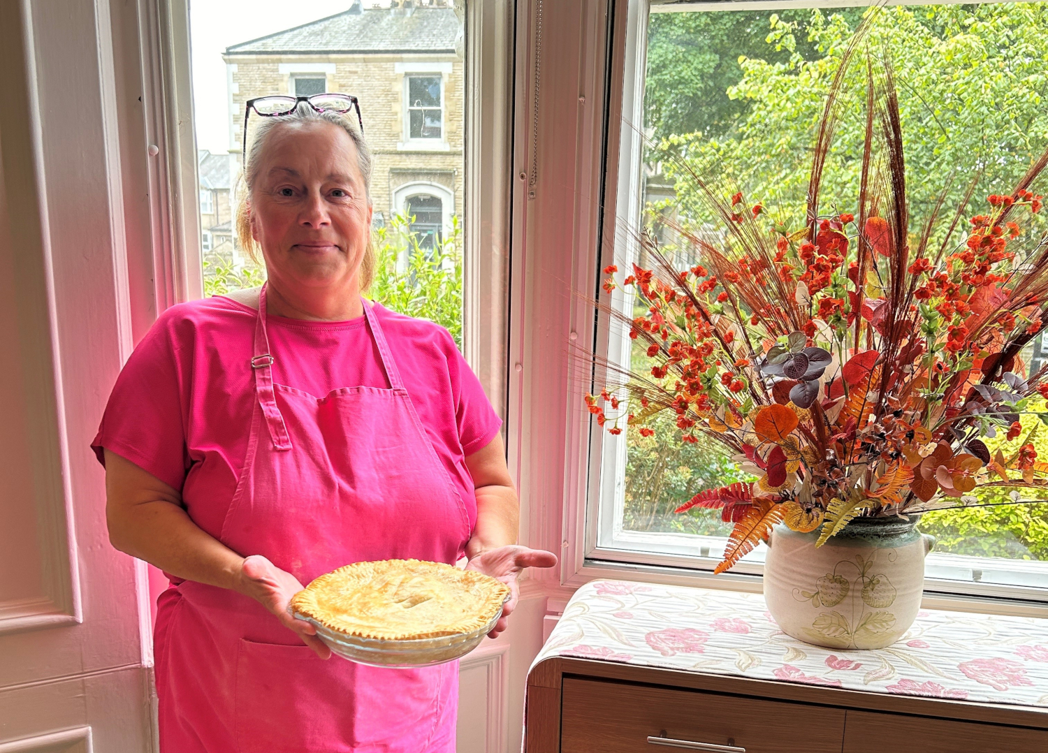 Staff Member Holding A Pie