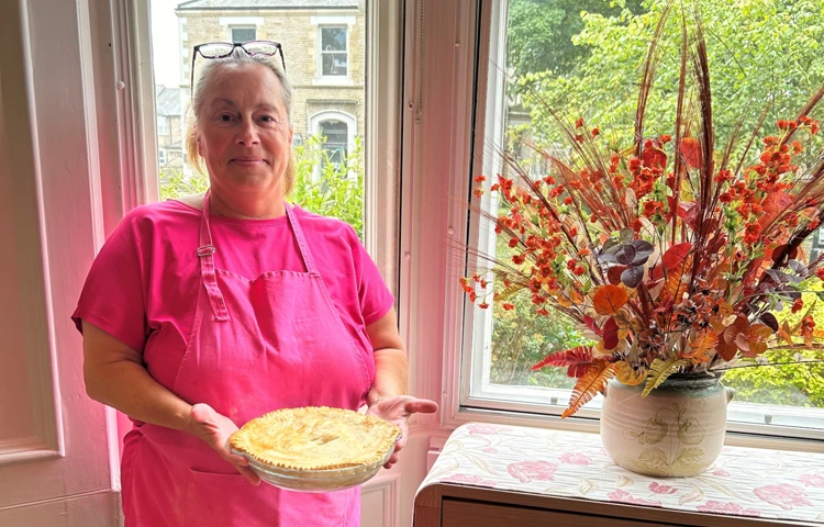 Staff Member Holding A Pie