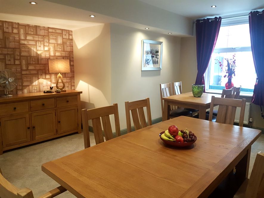 Large dining table with a basket of fruit