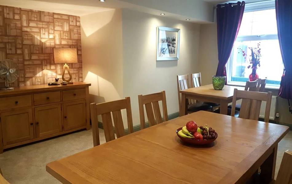 Large dining table with a basket of fruit
