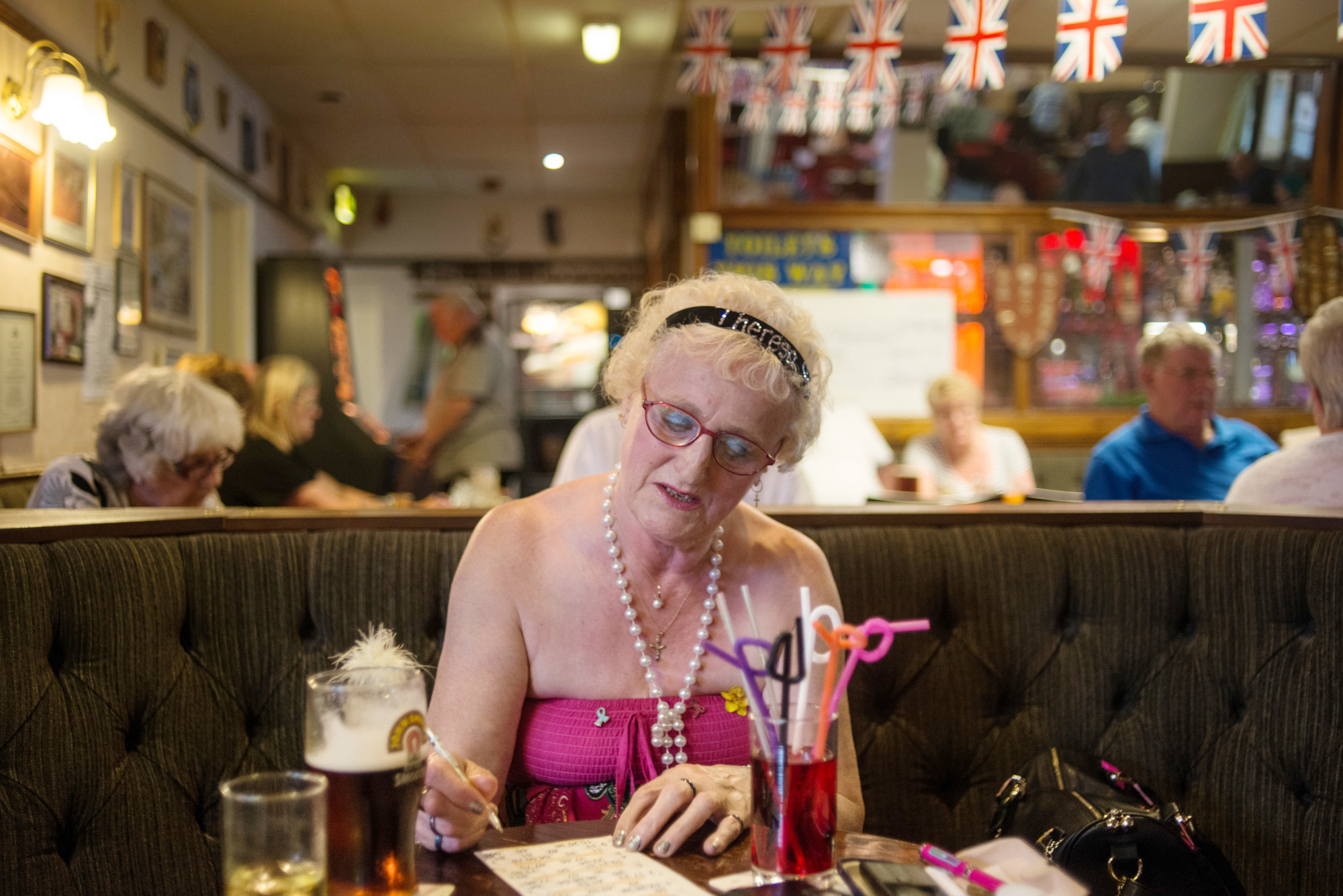 Older Woman Enjoying A Games Night At Pub