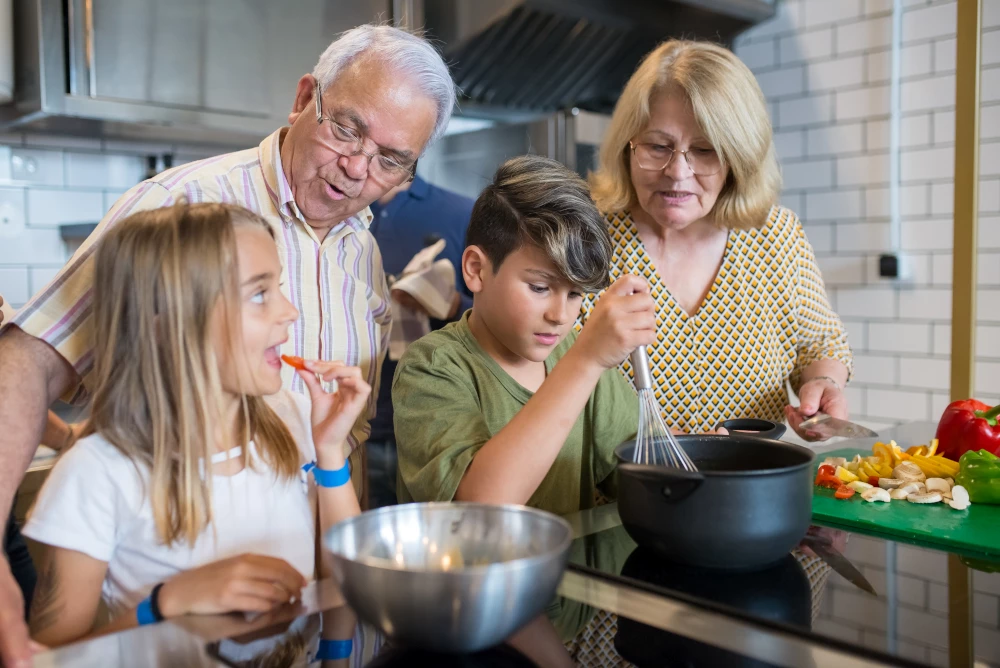 Grandchildren And Grandparents Cooking Together