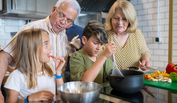 Grandchildren And Grandparents Cooking Together