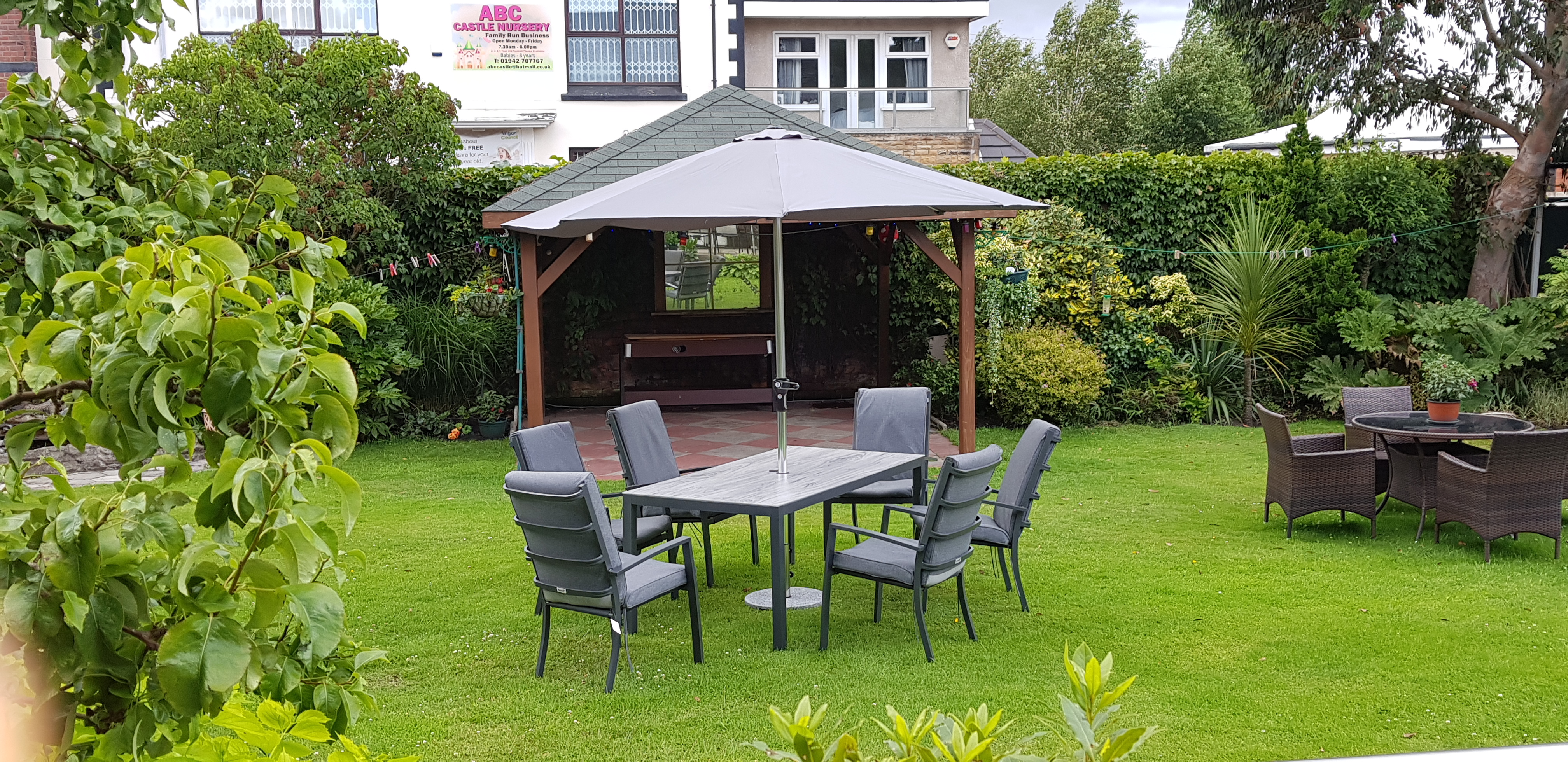 A garden table with chairs on the grass
