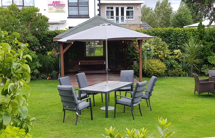 A garden table with chairs on the grass