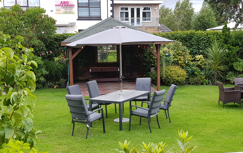 A garden table with chairs on the grass