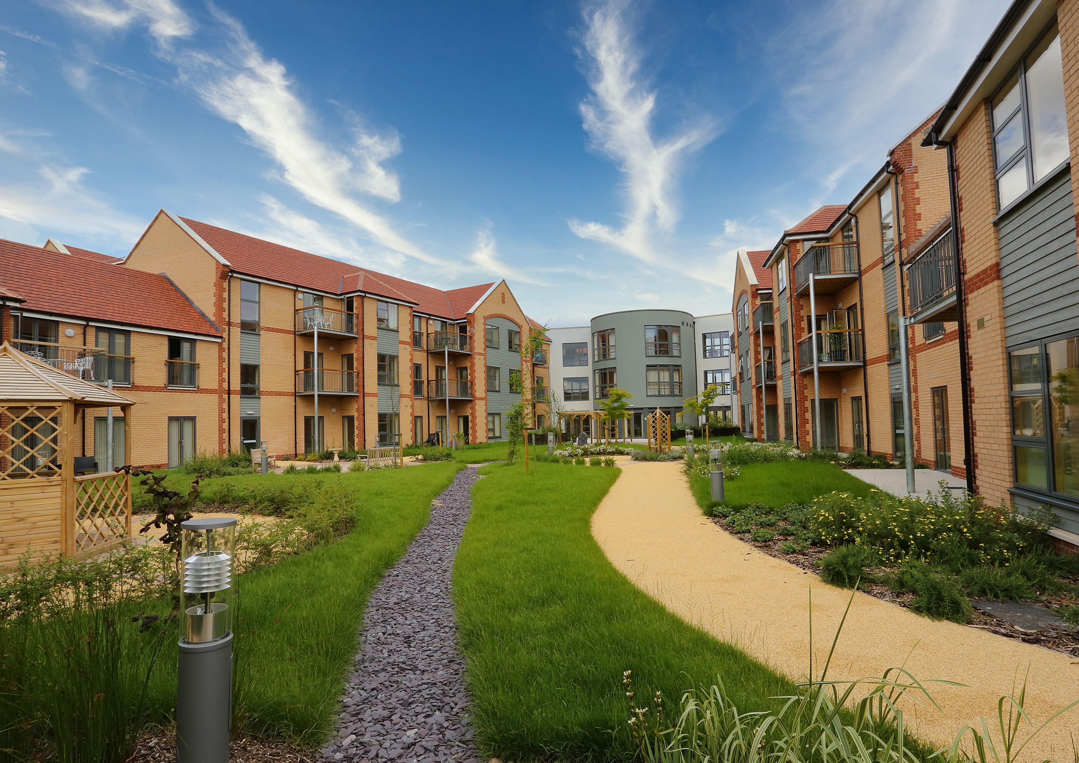 Exterior shot of Girton Green showing the ample, bright grounds where residents can enjoy the sunshine or a breath of fresh air