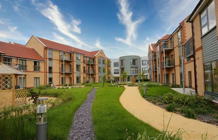 Exterior shot of Girton Green showing the ample, bright grounds where residents can enjoy the sunshine or a breath of fresh air