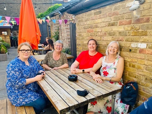 Four staff members at a bench
