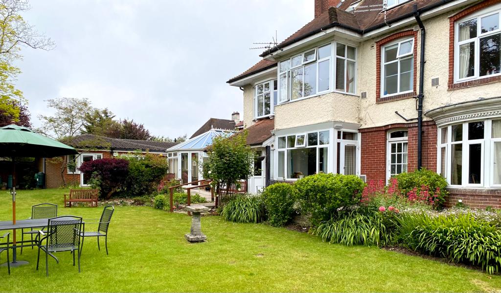 Back exterior of Abbeyfield House with spacious garden where residents can enjoy relaxing outdoors