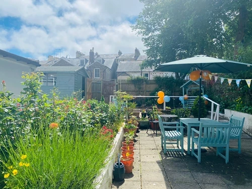 Garden patio with furniture, balloons and bunting