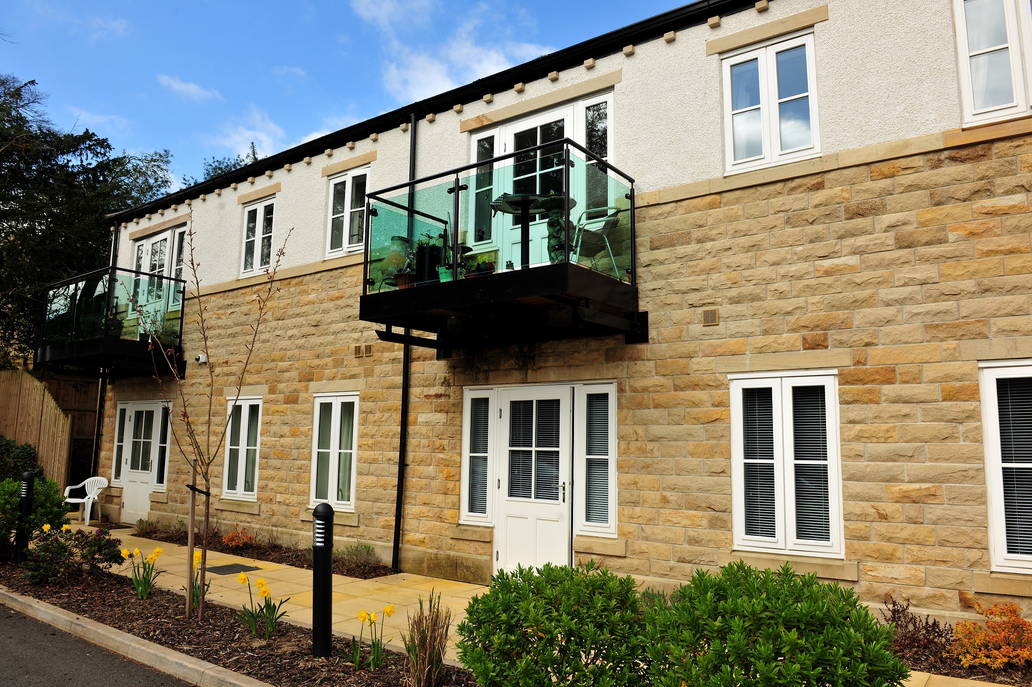 External view of Woodlands a stone house with glass balcony