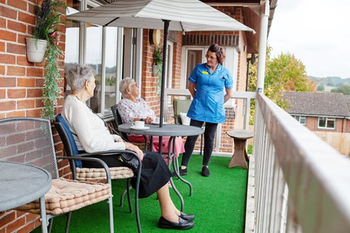 Residents And Staff On The Balcony at Friars Mead, Kings Langley WD4 8DR