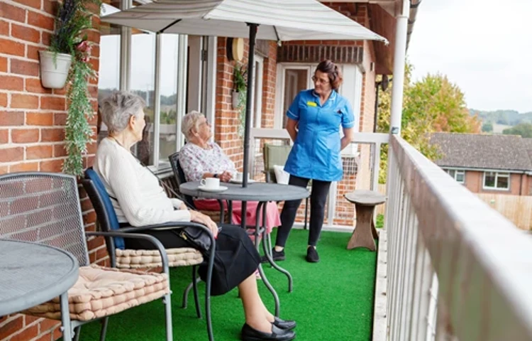 Residents And Staff On The Balcony at Friars Mead, Kings Langley WD4 8DR