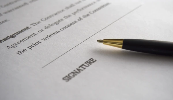 Close Up Of A Document And Pen