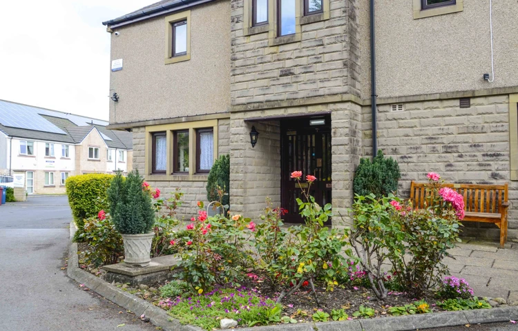 The entrance to the house with flower bed and bench at Castle View House, BB7 2DT